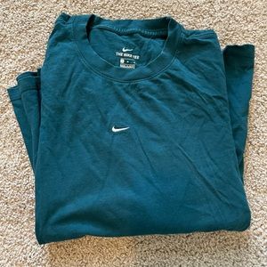Teal Nike long sleeve tshirt with black and white Nike pattern down the sleeves